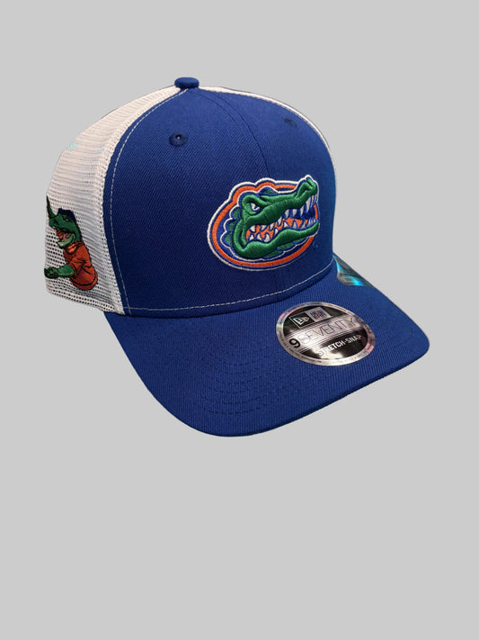 Blue and white cap with a gator logo on a reflective surface