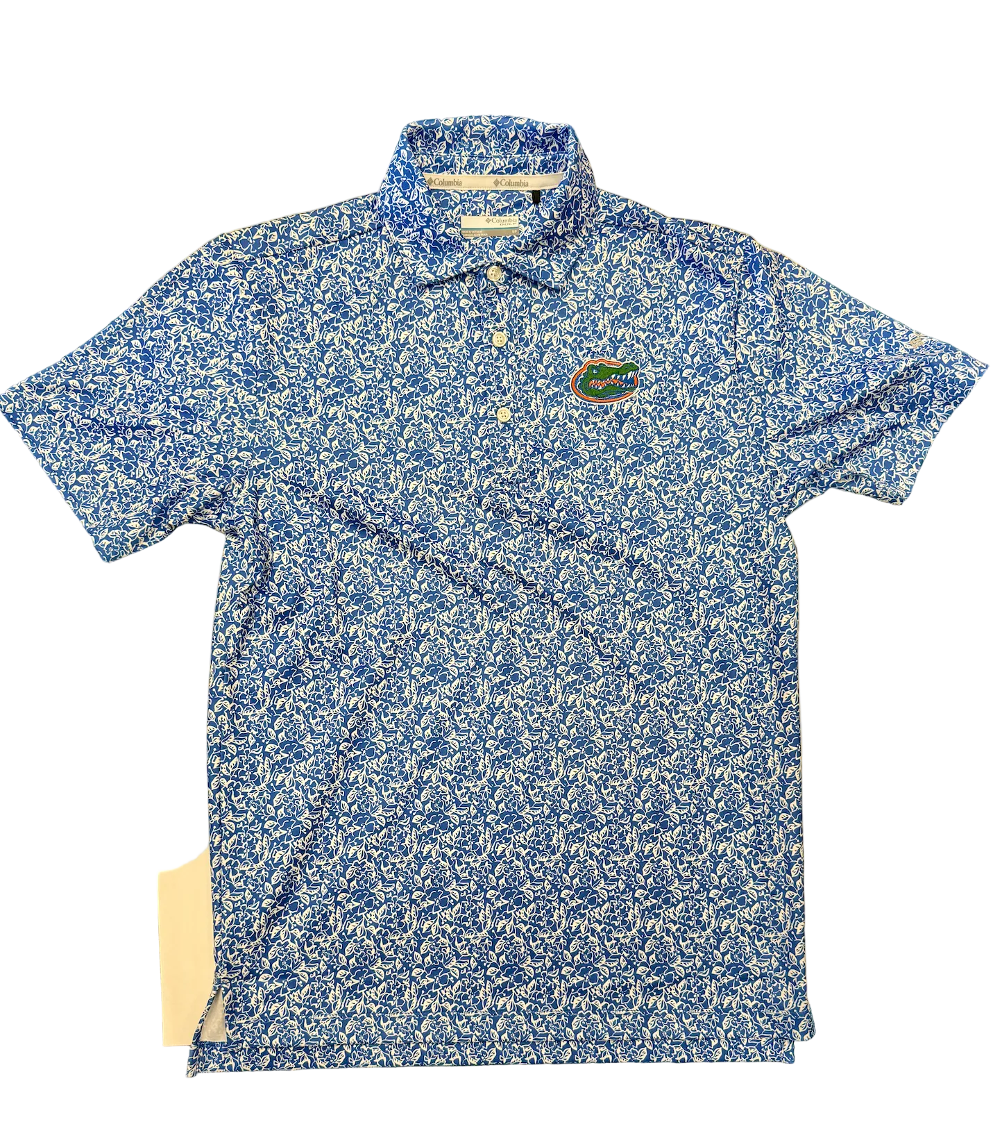 Blue patterned polo shirt with a logo on a green surface